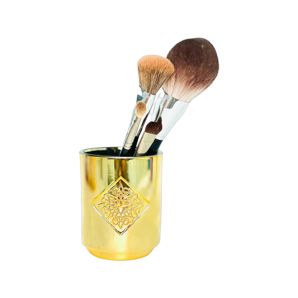 Load image into Gallery viewer, GOLDEN HOUR gold metallic OPAL ROAD scented candle repurposed as a makeup brush holder.

