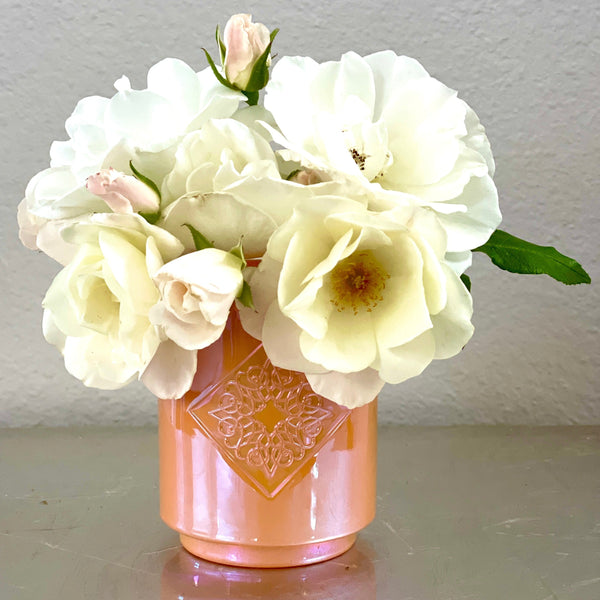 Load image into Gallery viewer, HARMONY orange iridescent OPAL ROAD scented candle repurposed as a flower vase.
